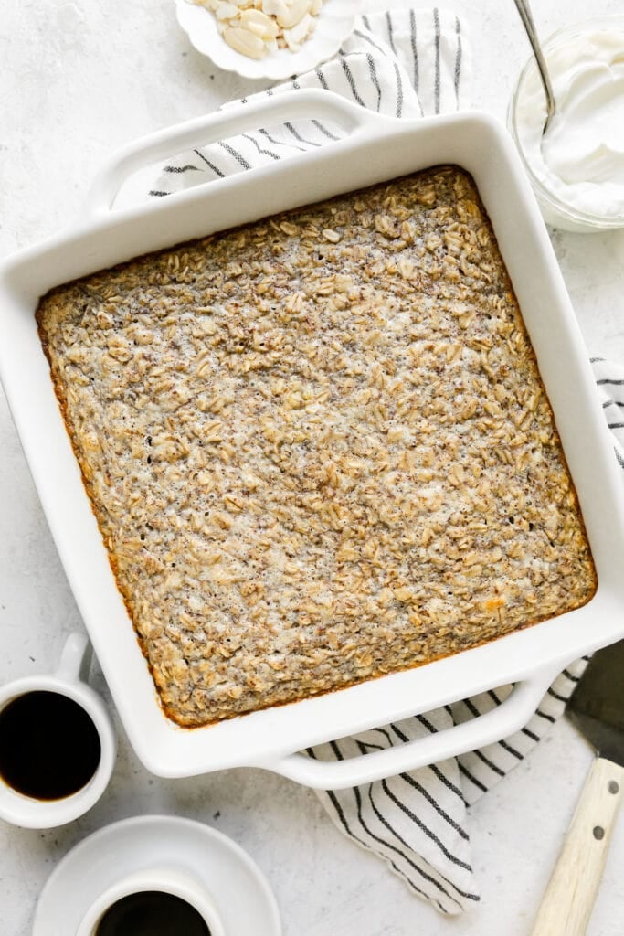 Overhead view of a freshly baked pan of Oatmeal with a cup of coffee next to it. 